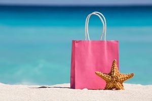 Shopping Bag And Starfish On Sand Against Turquoise Caribbean Se